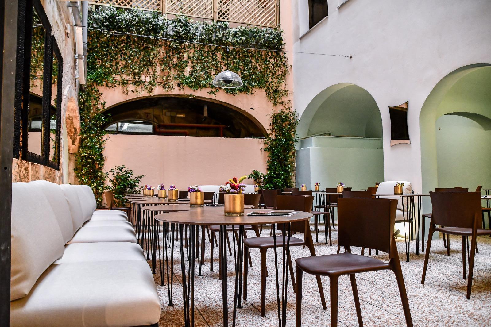 Al fresco dining under fairy lights and pastel arches