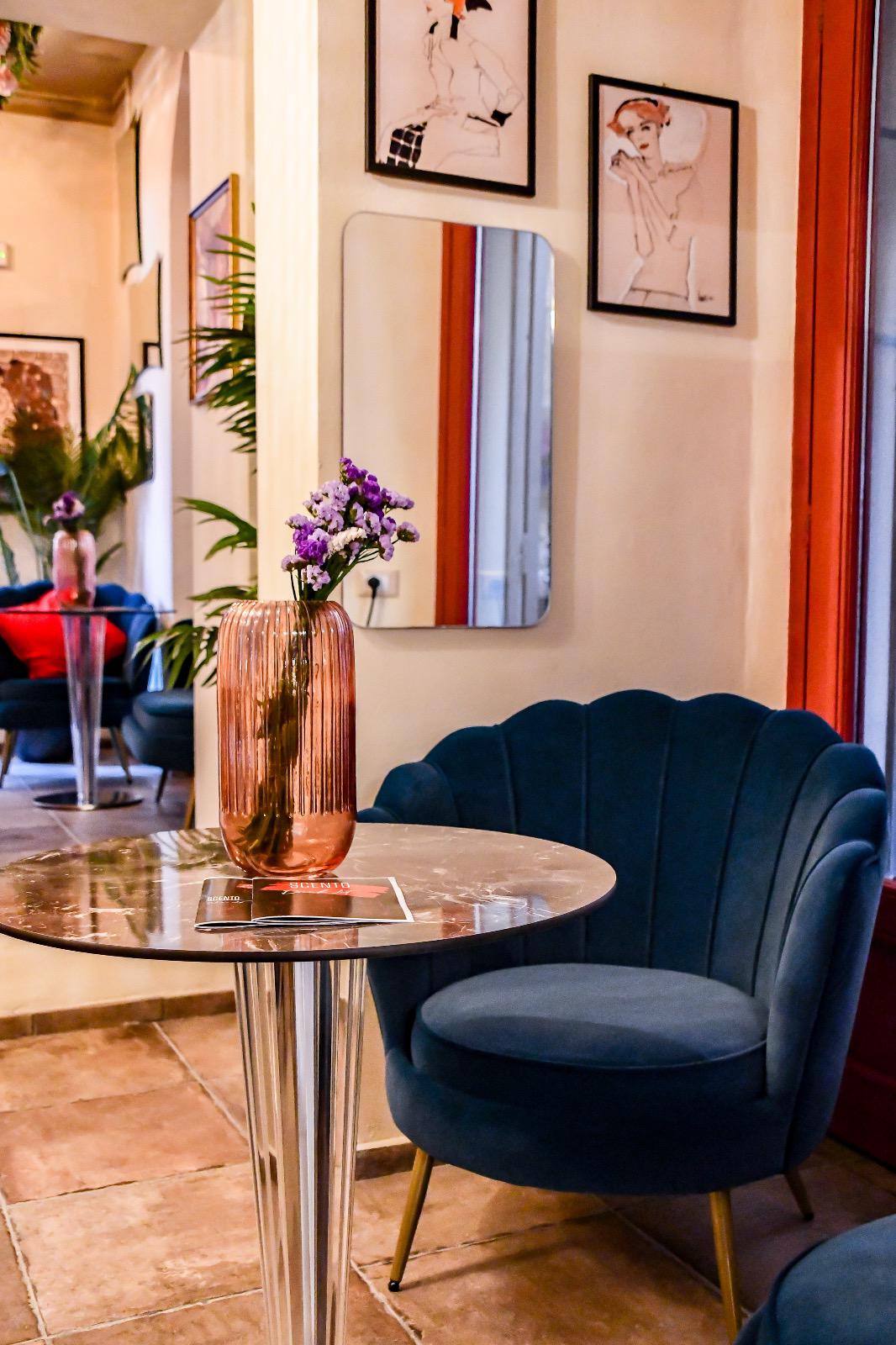 Velvet armchair with copper vase and fresh flowers